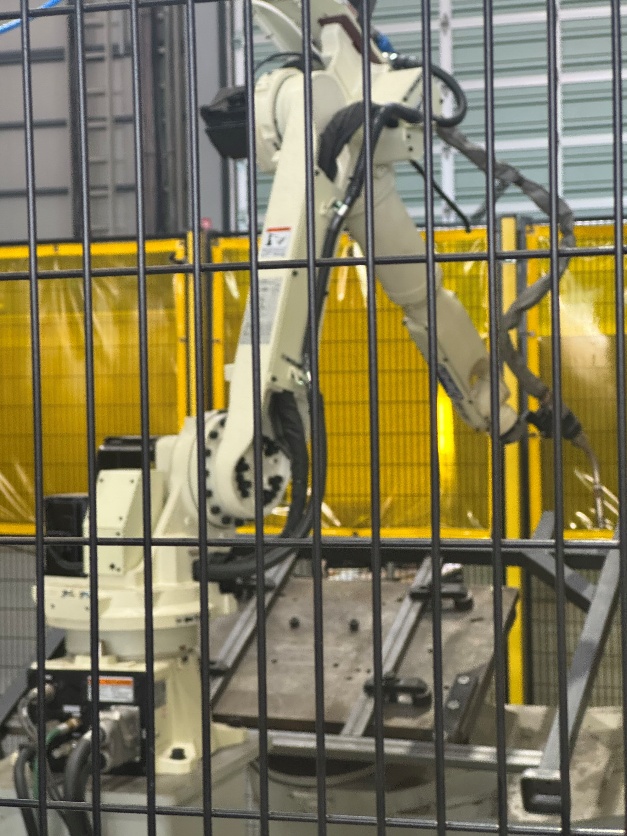 自動溶接ロボット。油圧ホース製作機などの設備を導入。